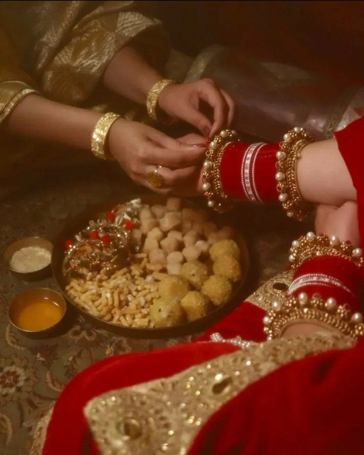 Choora ceremony detail with bangles, a red thread and a thali of sweets