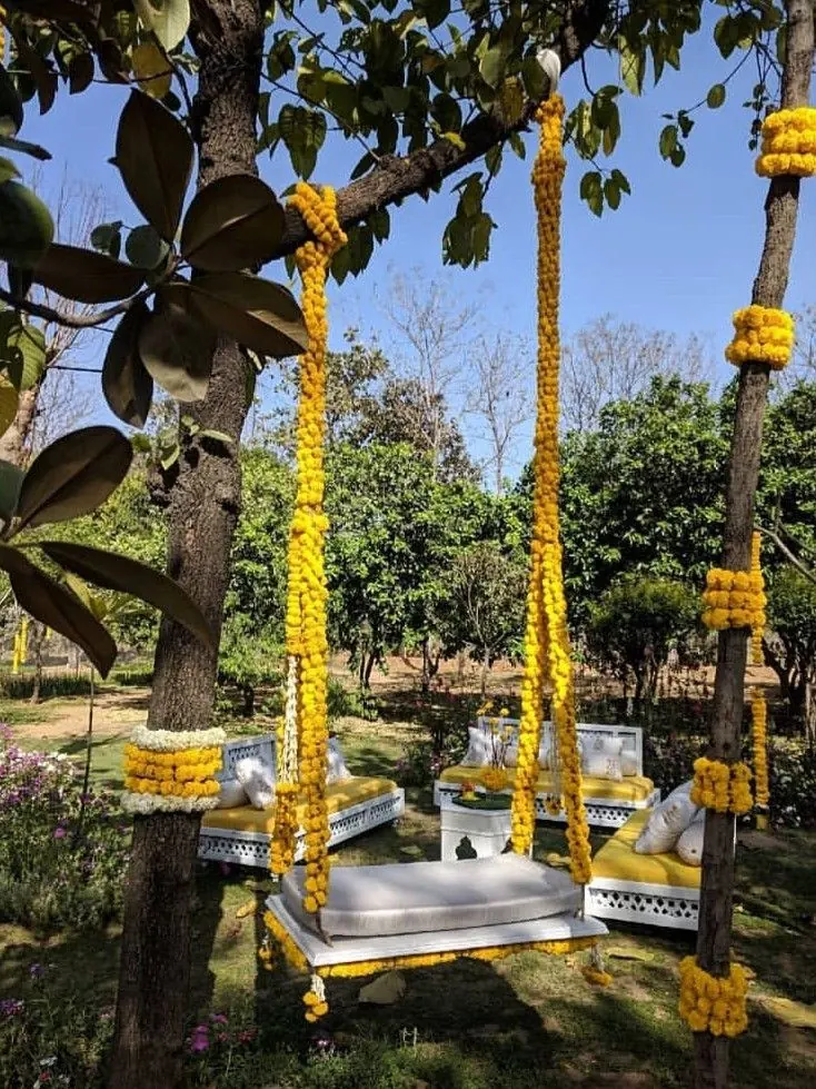 Garden jhula decorated with yellow marigold garlands for a Maiyan celebration