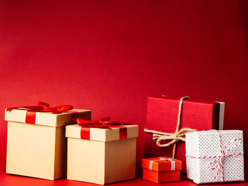 Wrapped gift boxes with red ribbons
