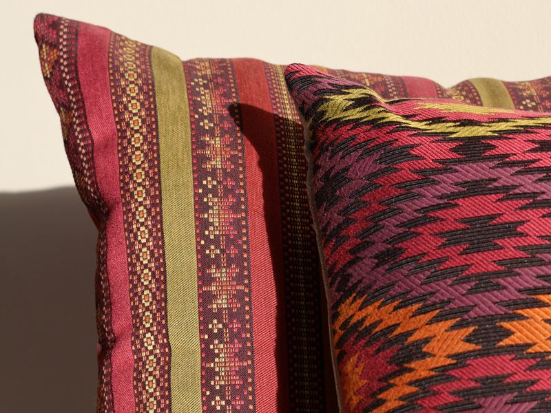 Colourful ethnic patterned cushion covers in warm tones