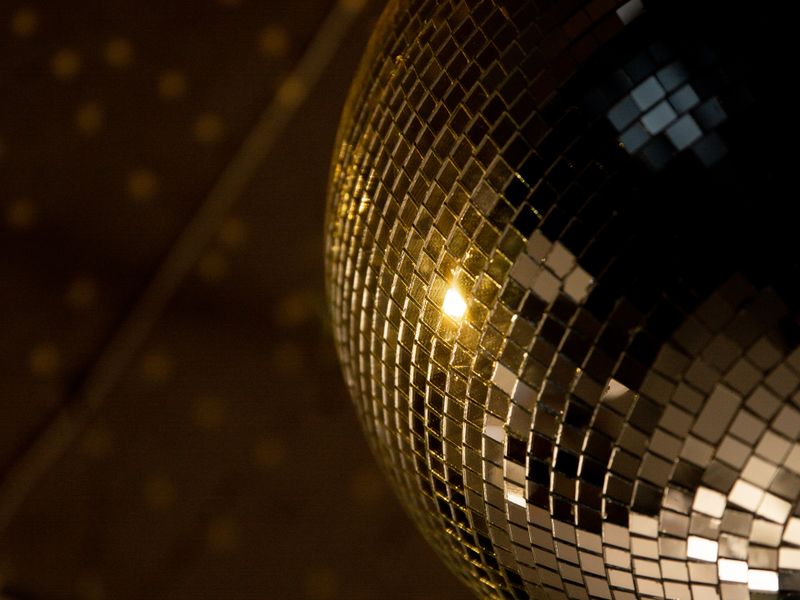 Gold disco ball reflecting warm light