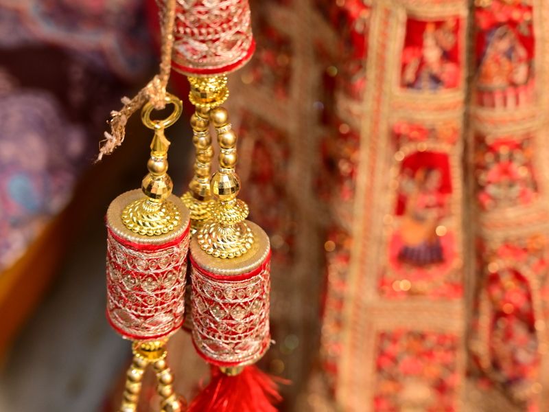 Red and gold bridal kaleere hanging in close-up