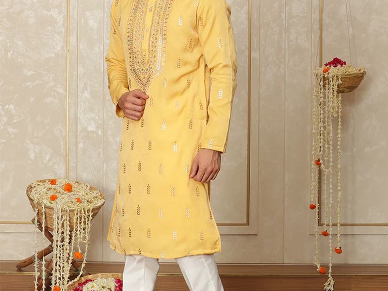 Yellow embroidered kurta pajama set on a model